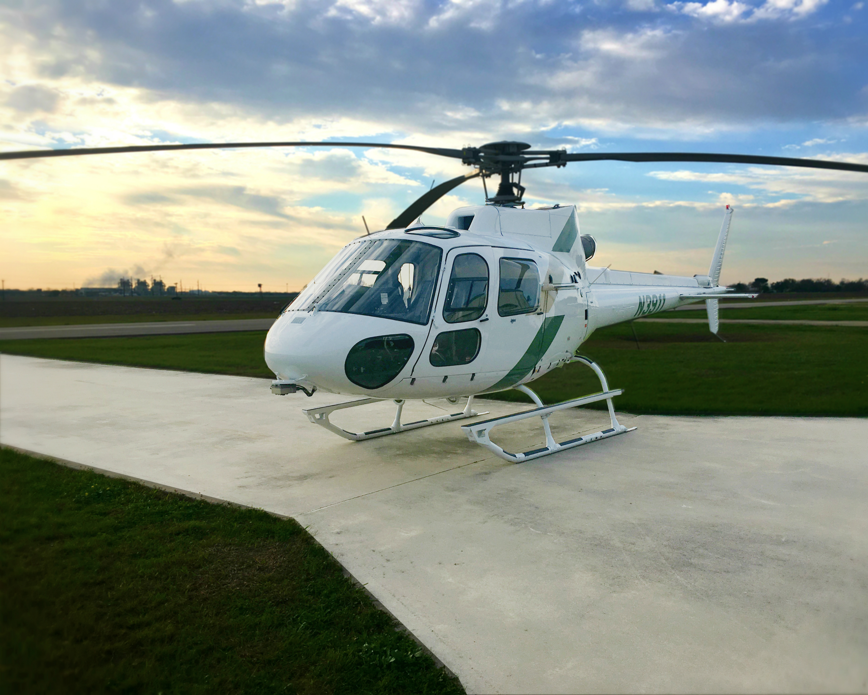 White and green helicopter for sale.